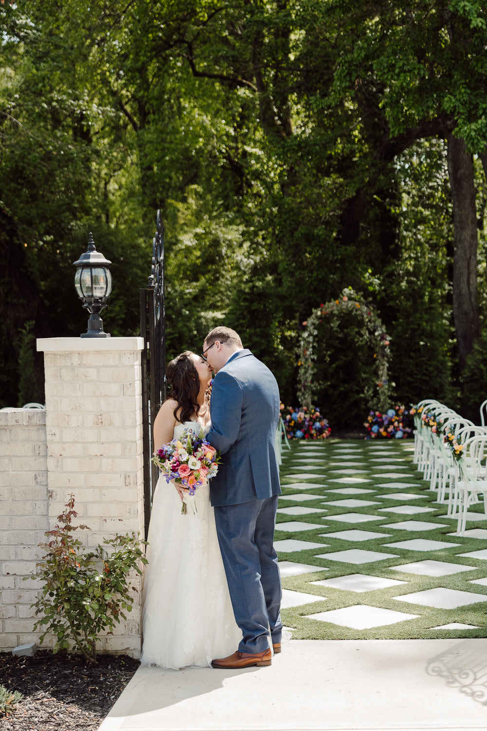 Bride and groom kissing at Greenhouse at Arrows Farm